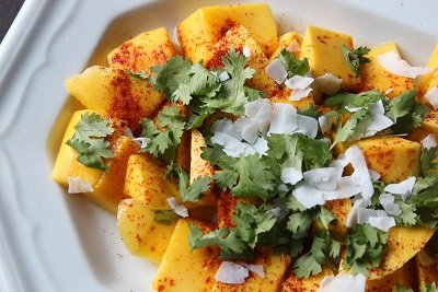 Mango fruit salad with coriander, coconut and chili powder - Mexican recipe
